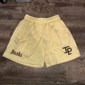 Inaka Yellow Shorts with Green Emblem